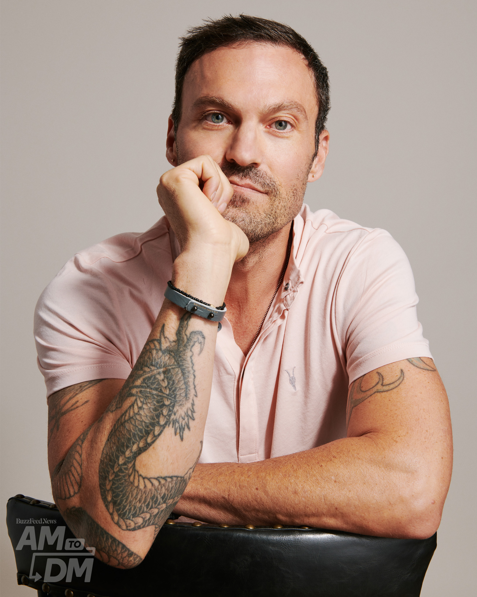 Portrait of Brian Austin Green wearing a light pink polo shirt in front of a taupe background background. CREDIT: JJ Reddington / BuzzFeed News