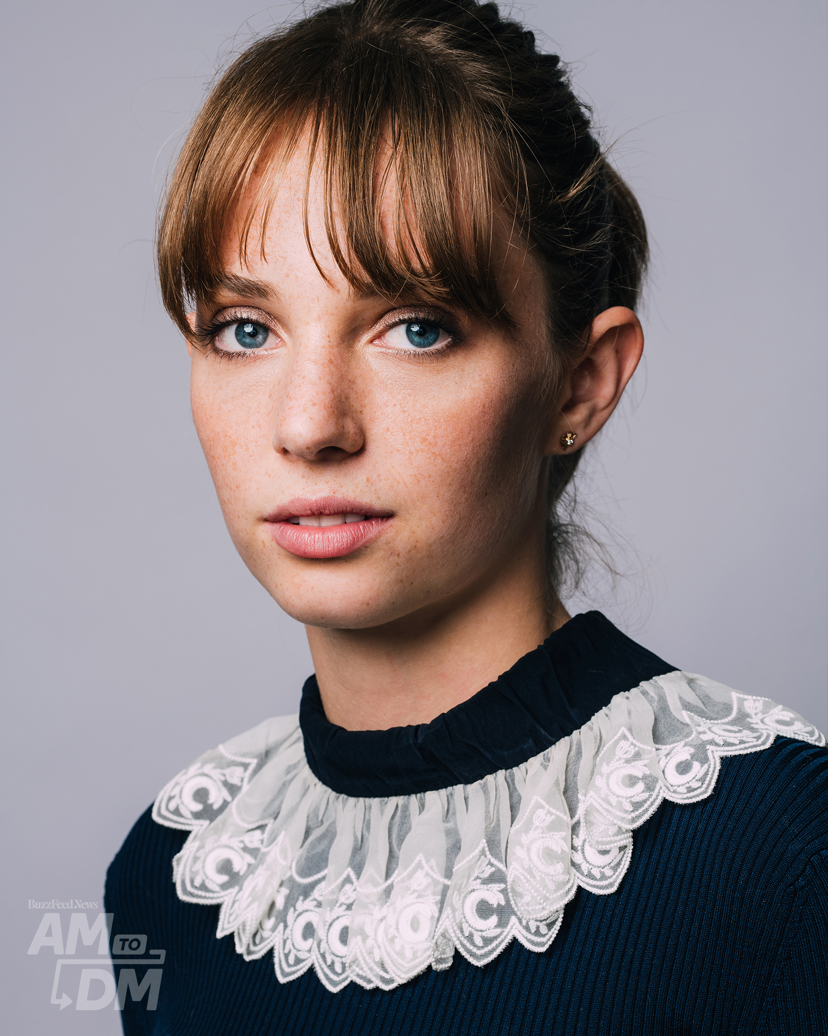 Portrait of Maya Hawke wearing a black top with a white lace collar in front of a light gray background background. CREDIT: Taylor Miller / BuzzFeed News