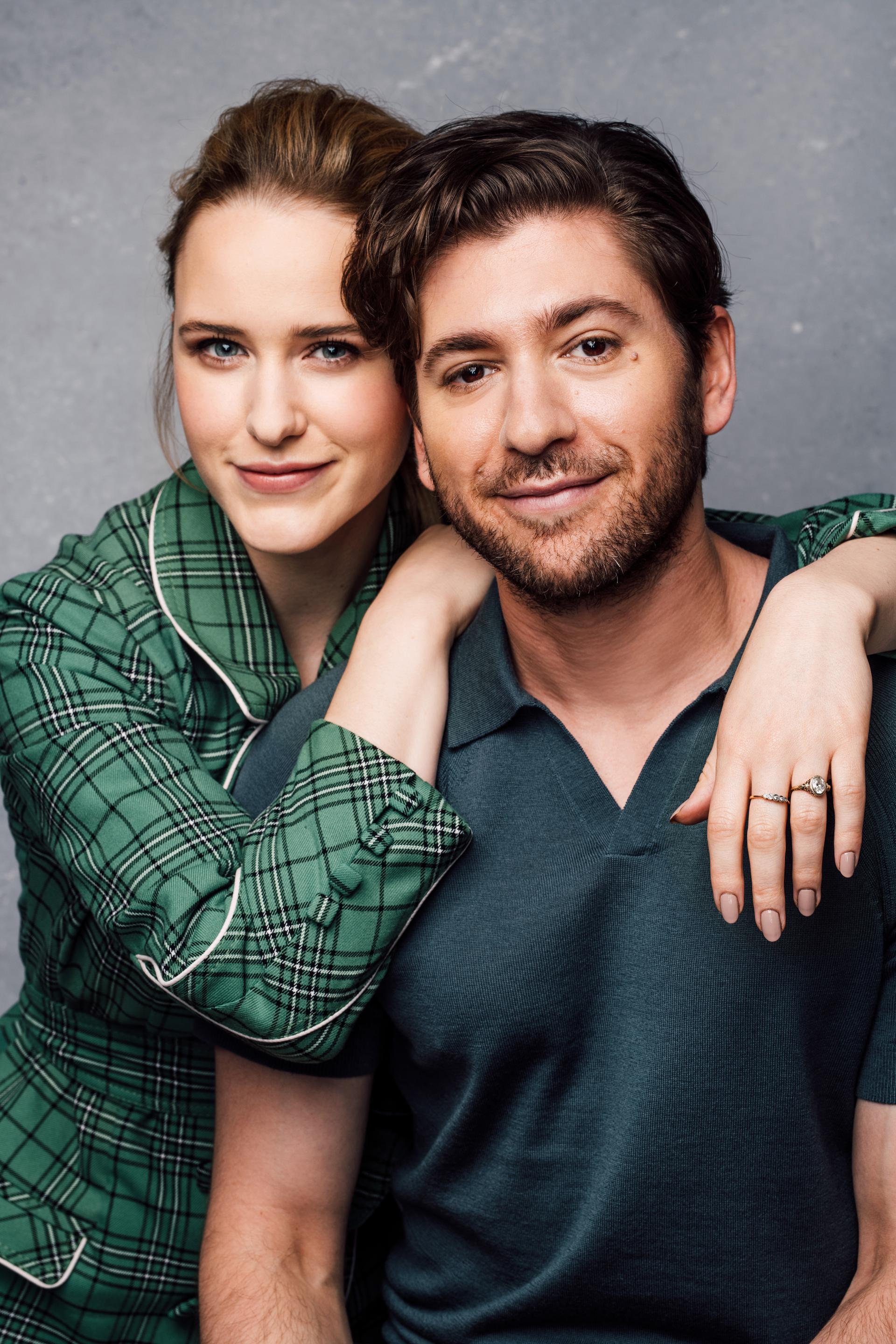 Portrait of Rachel Brosnahan wearing a green plaid blazer leaning on Michael Zegen, who's wearing a dark green polo shirt, in front of a gray background. CREDIT: Taylor Miller / BuzzFeed News
