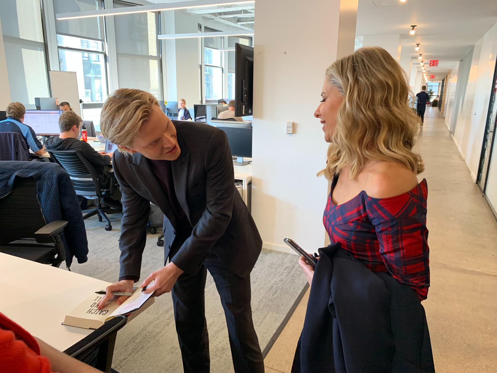 Ronan Farrow signing Sarah Michelle Gellar's copy of his book