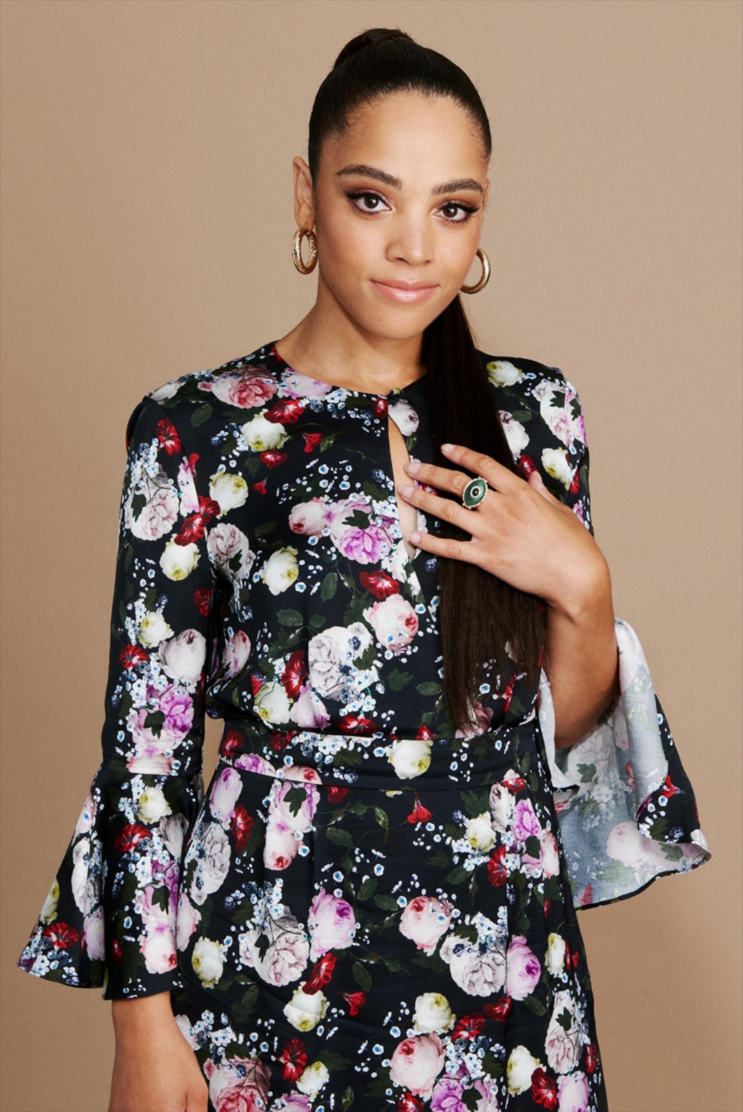 Portrait of Bianca Lawson wearing a floral dress in front of a taupe background. CREDIT: JJ Reddington / BuzzFeed News